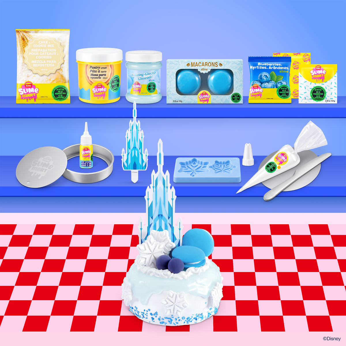 Slime dessert kit with icy cake slime, molds, squeeze bottle, and accessories on a check cloth