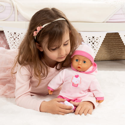 Pink baby doll with cupcake graphic dress, red-and-white striped hat and sleeves