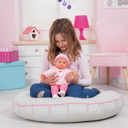 Pink baby doll in cupcake-printed romper and red-and-white striped cap
