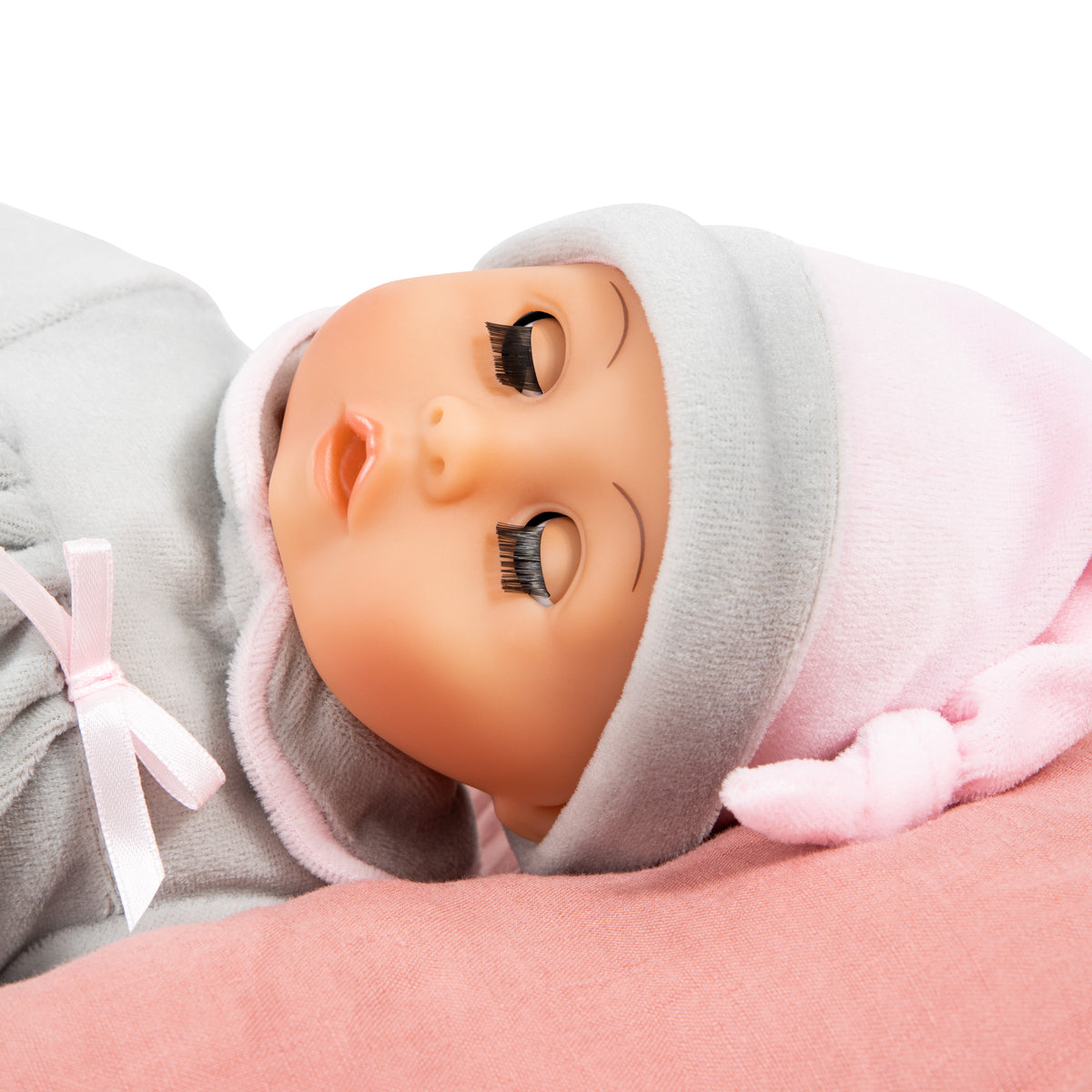Grey baby doll face close-up in hooded hat with soft pink trim