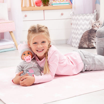 Grey baby doll in child's arms on bed, grey outfit with bunny snail print