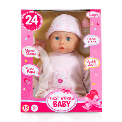 First Words baby doll in pink retail box with window, wearing frilly hat and outfit.