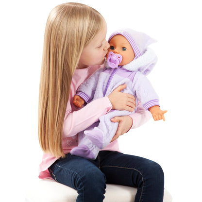 Child kissing a 46cm soft body baby doll while adjusting the purple pacifier