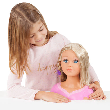 Blonde styling doll head in pink dress top, held by a child