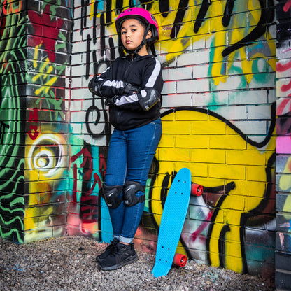 Blue skateboard leaning near a person, orange wheels visible