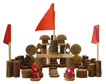 Wooden castle blocks set with red flags, central ladder, and small toy figures