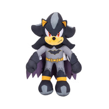 Dark gray and black bat-themed plush character with yellow eyes and cape