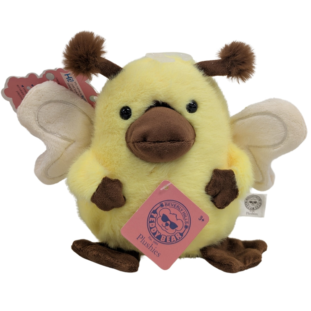 Yellow and brown plush animal toy with stitched face and hanging heart tag