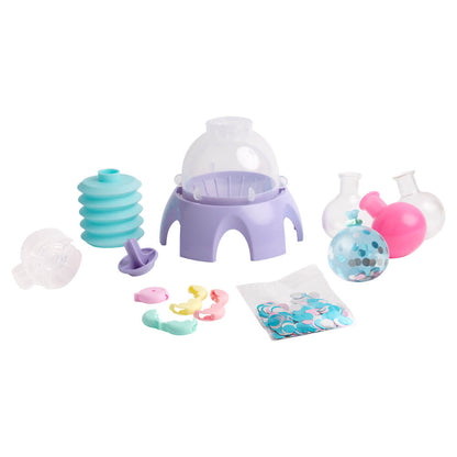 Mini squishy maker kit pieces: purple base, clear dome, molds, and colorful accessories.