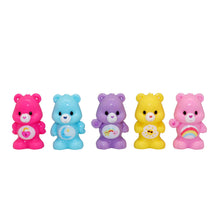 Five colorful Care Bears Ooshies bear figures: pink, blue, purple, yellow, and pink