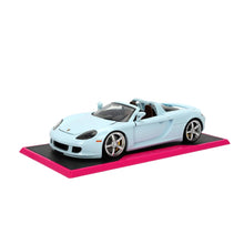 Light blue Porsche Carrera GT diecast on magenta display base, chrome wheels