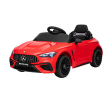 Red kids electric ride-on car with black steering wheel and LED headlights, angled view
