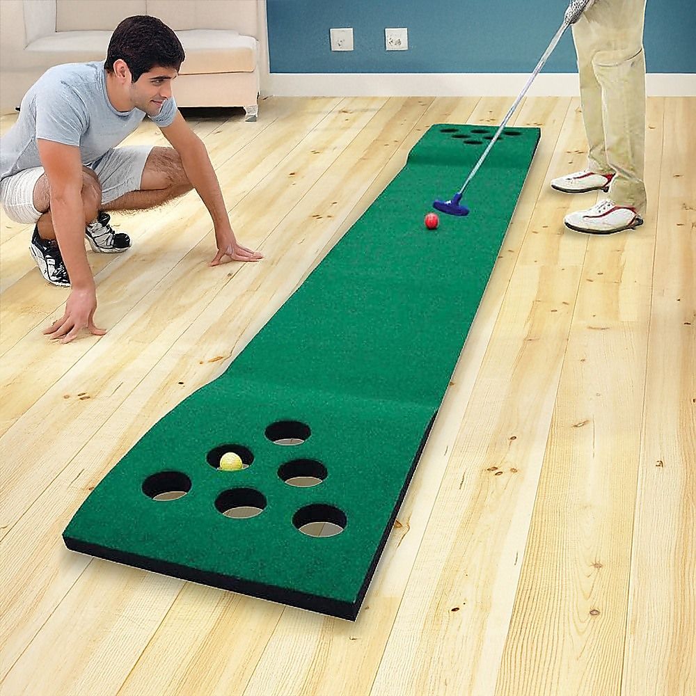Green golf putting mat with cup holes; includes putters and small balls game set