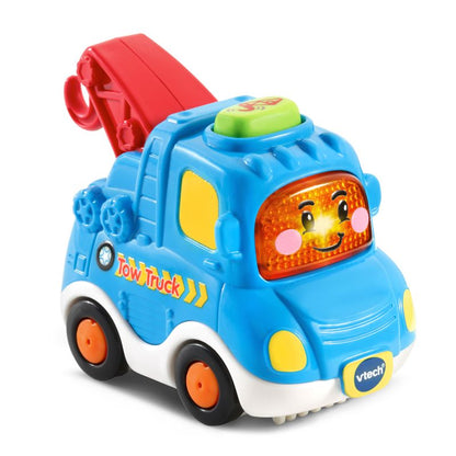 Blue toy tow truck vehicle with red cab, amber light, and smiling driver face