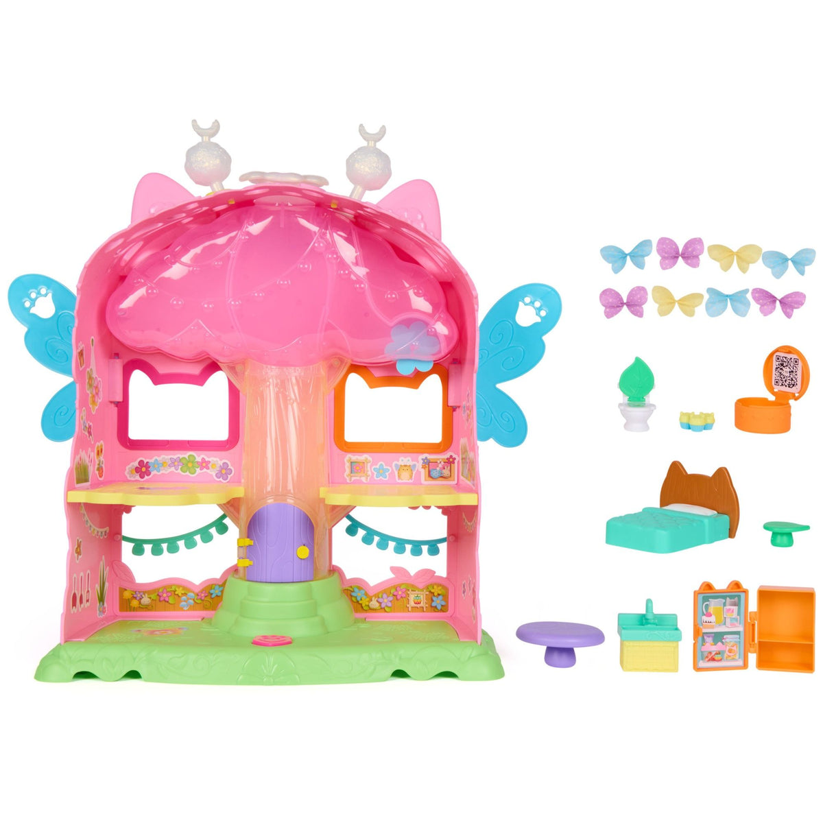 Pink fairy dollhouse playset with open front, green base, and accessory parts included