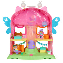 Fairy dollhouse playset with pink curved roof, open rooms, display shelves, and doll figure