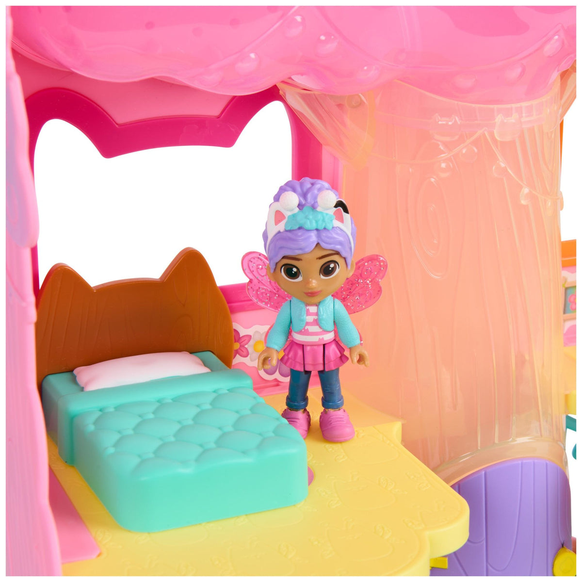 Fairy dollhouse interior with teal bed and standing fairy doll figure under pink arch