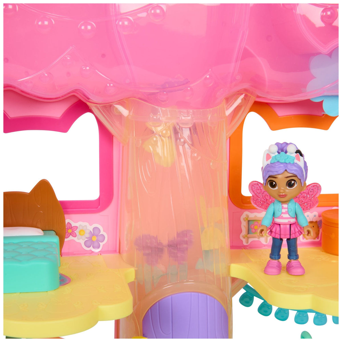 Fairy dollhouse interior with pink canopy and small seated doll figure inside alcove