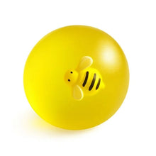 Yellow squishy ball with bee face and three black stripes detail